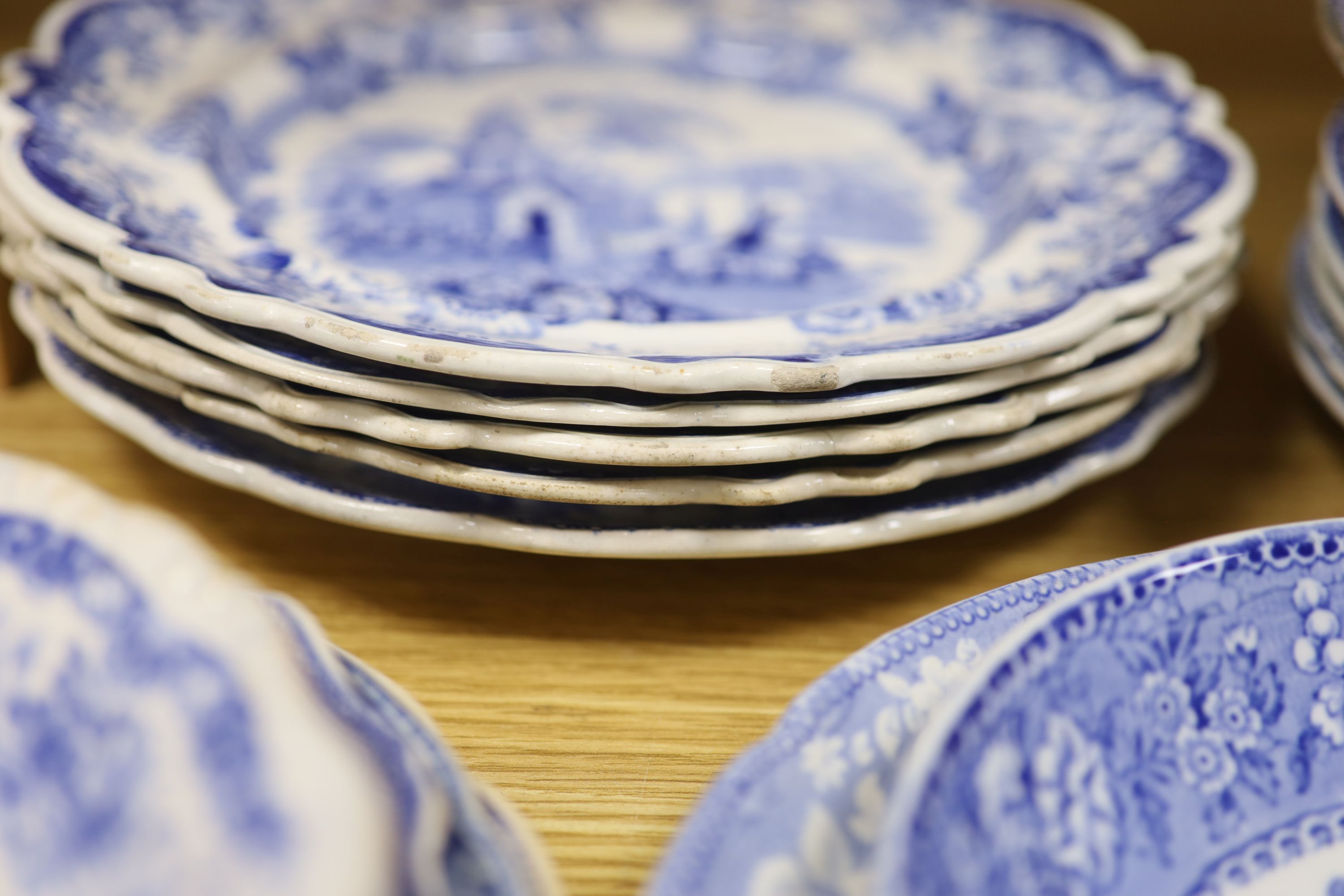 A collection of 19th and 20th century blue and white pottery plates and dishes